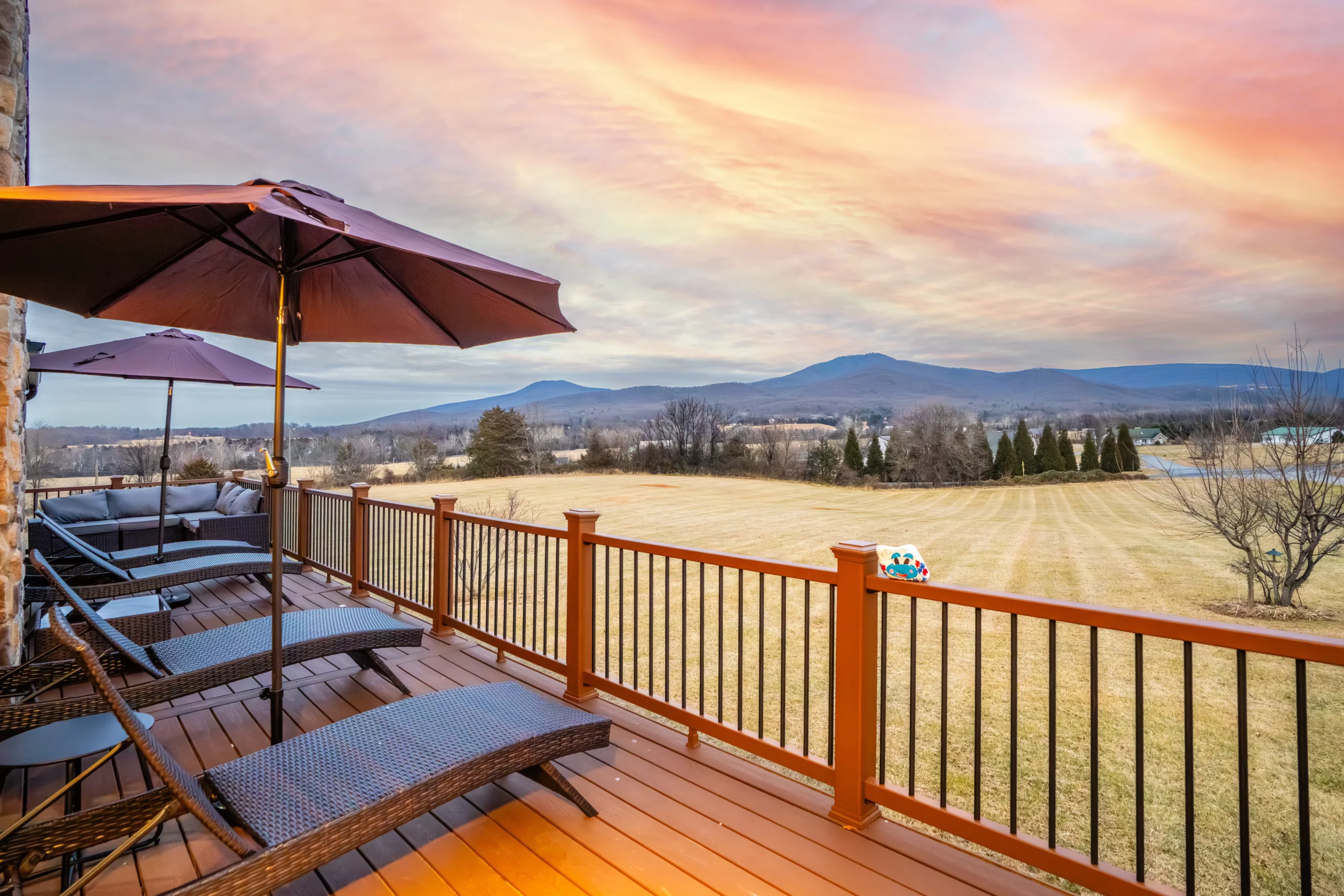 Elevated deck with mountain valley views and lounge seating in Luray cabin for large groups