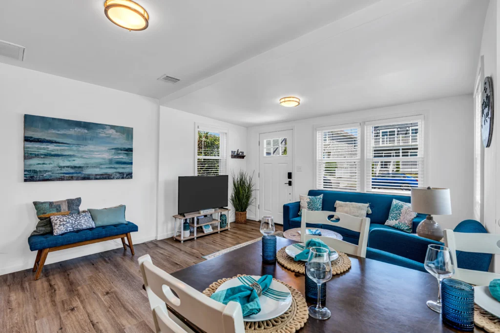 Open-concept living room with coastal design and blue seating in Belmar vacation rental