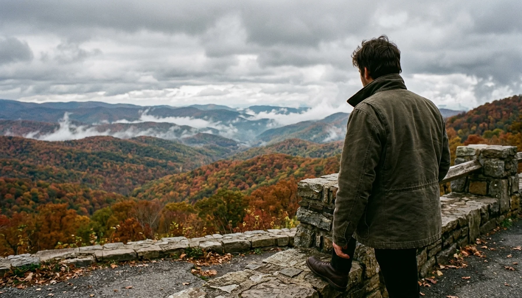 Visitor at a Skyline Drive overlook taking in peak Shenandoah fall foliage colors