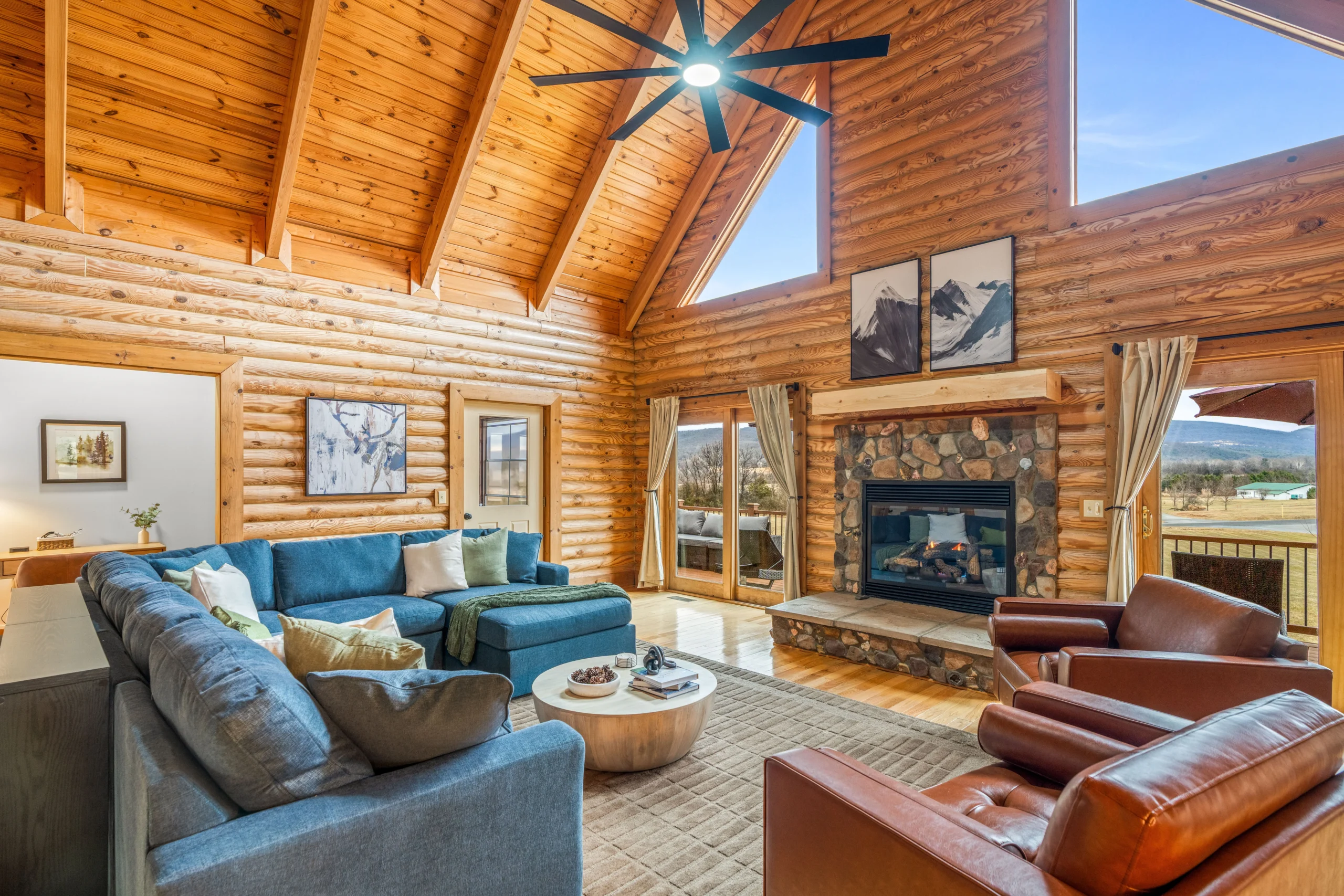 Log cabin living room with stone fireplace and mountain views near Luray, VA