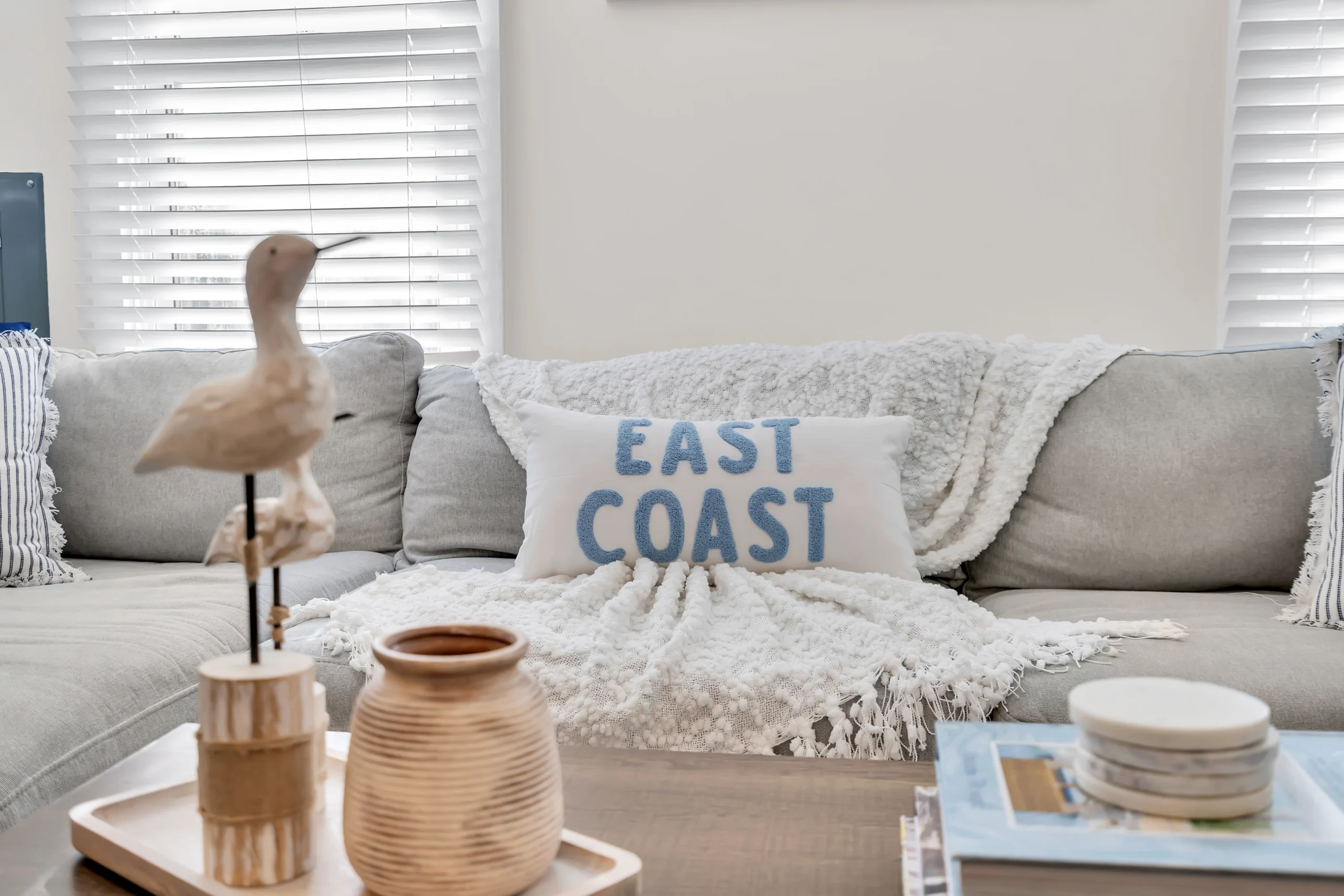 Coastal living room with gray sofa and east coast decor in Ocean Grove vacation rental