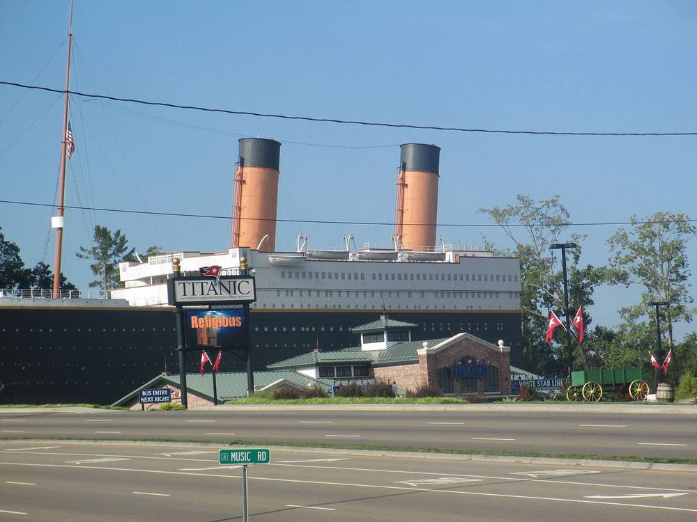 The half-scale Titanic Museum hull moored in still water on the Pigeon Forge Parkway