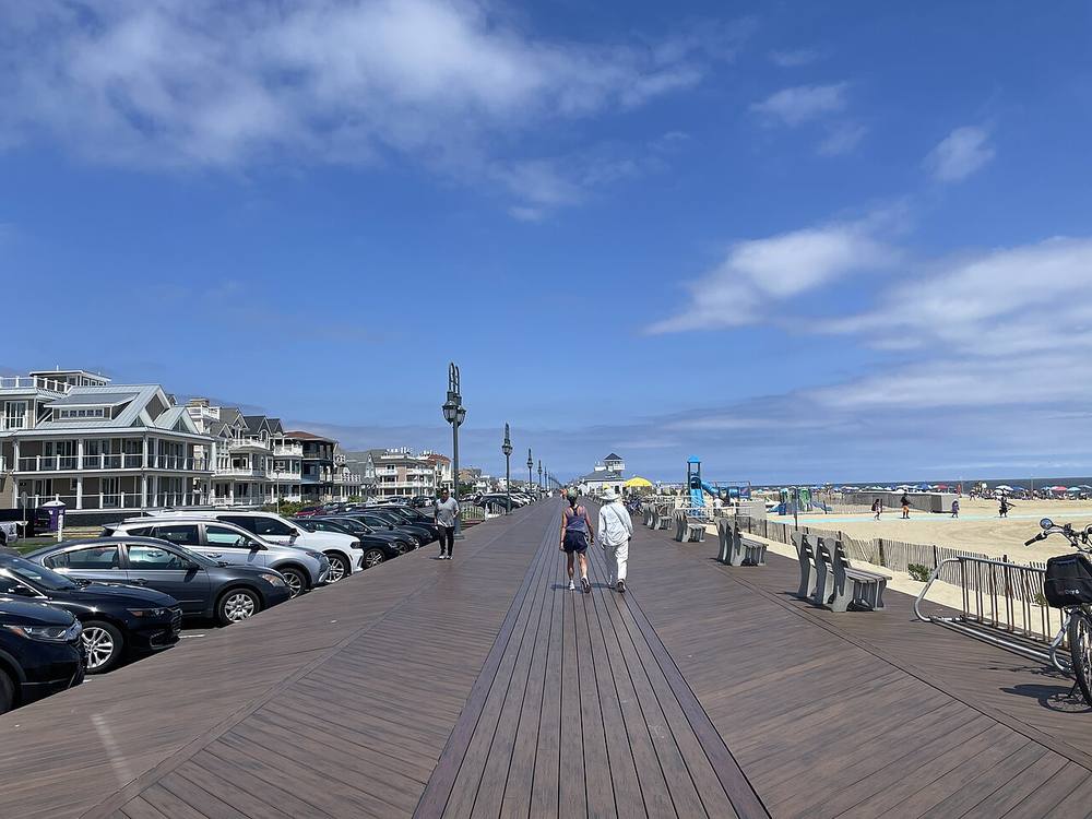 The Belmar boardwalk looking north at 13th Avenue, with the beach and dune fence alongside