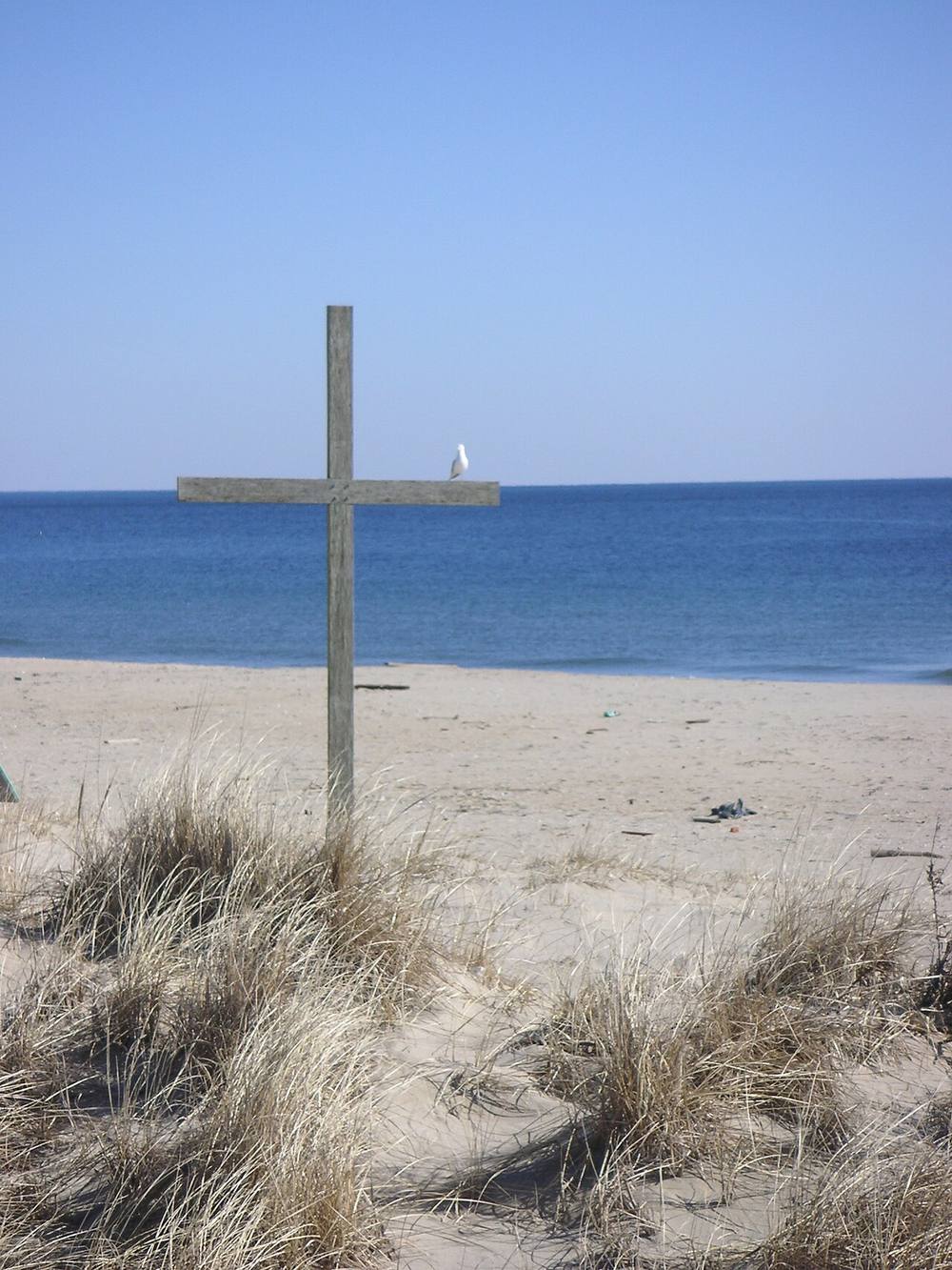 Ocean Grove's beach on a clear day, looking down the sand toward the boardwalk